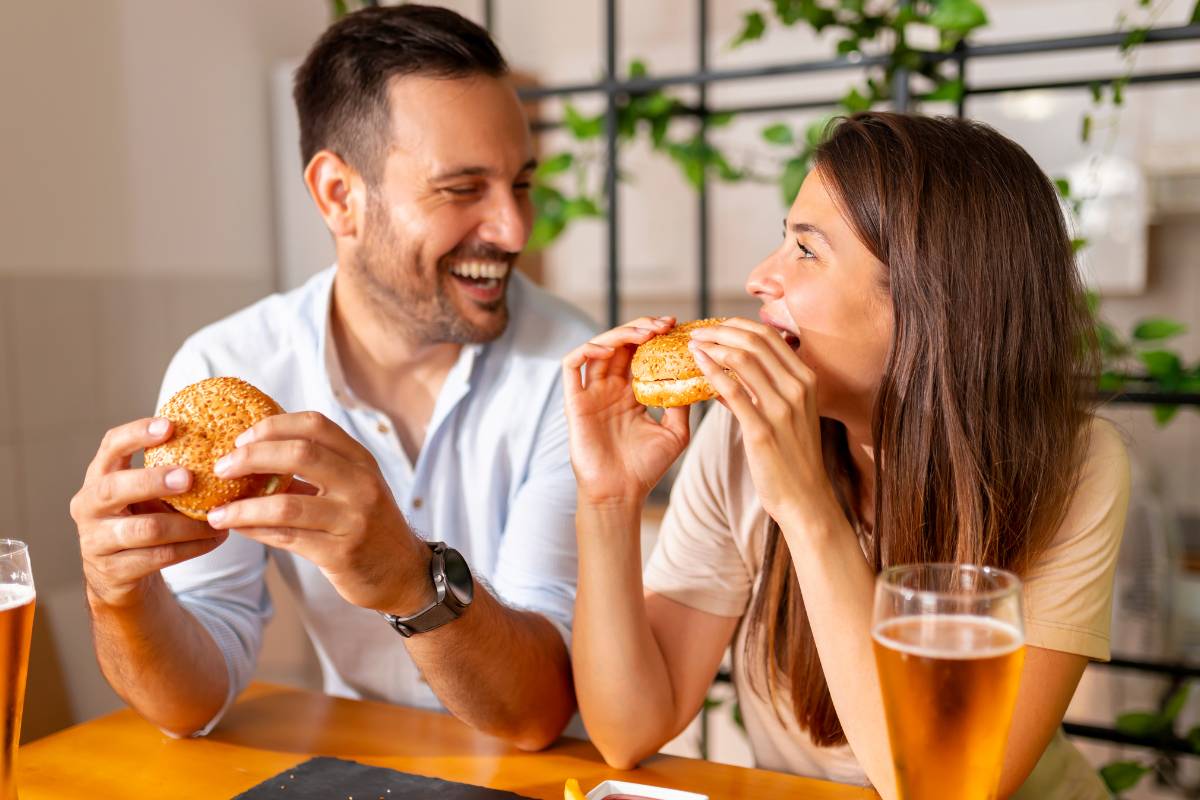 national burger day celebration - a couple enjoying their burger meal together